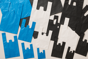 a lot of plastic t shirt bags blue white and black all sizes